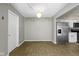 Bright dining room with stylish light fixture and a view into the kitchen at 9464 Fordham St, Indianapolis, IN 46268
