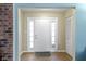 Inviting entryway with a white door, side windows, and wood-look flooring at 9464 Fordham St, Indianapolis, IN 46268