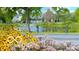 Picturesque neighborhood with lush landscaping, pond with fountain and traditional homes at 9464 Fordham St, Indianapolis, IN 46268
