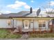 Charming single-story home featuring a covered front porch and landscaped front yard at 9464 Fordham St, Indianapolis, IN 46268