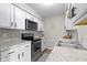 Bright kitchen featuring stainless steel appliances, granite counters, and white cabinets at 9464 Fordham St, Indianapolis, IN 46268