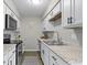 Stylish kitchen with stainless appliances, granite countertops, and sleek white cabinetry at 9464 Fordham St, Indianapolis, IN 46268