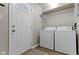 Functional laundry room with washer, dryer, and a door to the exterior at 9464 Fordham St, Indianapolis, IN 46268