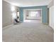 Spacious living room with neutral carpet, natural light, and an adjacent bonus room at 9464 Fordham St, Indianapolis, IN 46268