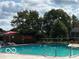 Community pool area with lounge seating and lush greenery, perfect for relaxation at 9464 Fordham St, Indianapolis, IN 46268