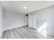 This bedroom features neutral walls, modern gray vinyl floors, and a closet for optimal storage at 9525 Meadowlark Dr, Indianapolis, IN 46235