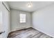 This bedroom features a window offering natural light and modern gray vinyl floors throughout at 9525 Meadowlark Dr, Indianapolis, IN 46235
