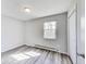 This bedroom features a window offering natural light and modern gray vinyl floors throughout at 9525 Meadowlark Dr, Indianapolis, IN 46235