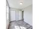 This bedroom features neutral walls, modern gray vinyl floors, and a closet for optimal storage at 9525 Meadowlark Dr, Indianapolis, IN 46235