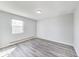 Cozy bedroom featuring neutral walls, and modern wood-look flooring creating a peaceful retreat at 9525 Meadowlark Dr, Indianapolis, IN 46235