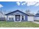Charming one-story home features a blue exterior, white trim, and an attached one-car garage at 9525 Meadowlark Dr, Indianapolis, IN 46235