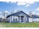 Charming one-story home features a blue exterior, white trim, and an attached one-car garage at 9525 Meadowlark Dr, Indianapolis, IN 46235