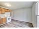 Functional kitchen featuring wood cabinets, white appliances, and new floors for a fresh look at 9525 Meadowlark Dr, Indianapolis, IN 46235