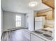 Functional kitchen featuring wood cabinets, white appliances, and new floors for a fresh look at 9525 Meadowlark Dr, Indianapolis, IN 46235
