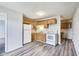 Functional kitchen featuring wood cabinets, white appliances, and new floors for a fresh look at 9525 Meadowlark Dr, Indianapolis, IN 46235