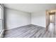Bright living room featuring gray walls, wood-look floors and a large window providing ample natural light at 9525 Meadowlark Dr, Indianapolis, IN 46235