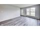 Bright living room featuring gray walls, wood-look floors and a large window providing ample natural light at 9525 Meadowlark Dr, Indianapolis, IN 46235