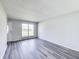 Bright living room featuring gray walls, wood-look floors and a large window providing ample natural light at 9525 Meadowlark Dr, Indianapolis, IN 46235