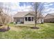 Cozy backyard with a patio, screened in porch, and a well-maintained lawn at 9752 Brook Wood Dr, McCordsville, IN 46055