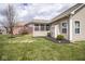 Spacious backyard with well-maintained lawn, mulch beds, and partial view of the screened in porch at 9752 Brook Wood Dr, McCordsville, IN 46055