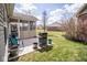 Outdoor patio featuring grill, seating area and screened in porch overlooking a manicured lawn at 9752 Brook Wood Dr, McCordsville, IN 46055