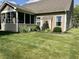 Well maintained lawn, partial view of screened-in porch with decorative landscaping adjacent to the house at 9752 Brook Wood Dr, McCordsville, IN 46055