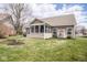 Beautiful backyard featuring a screened in porch and a lush green lawn at 9752 Brook Wood Dr, McCordsville, IN 46055