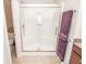 Bathroom featuring a modern shower with sliding glass doors, and neutral tile flooring for a clean look at 9752 Brook Wood Dr, McCordsville, IN 46055
