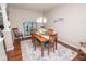 Inviting dining room with stylish furniture, a modern light fixture, and an adjacent accent cabinet at 9752 Brook Wood Dr, McCordsville, IN 46055