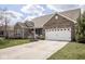 Charming single-Gathering home features beautiful landscaping and a welcoming two-car garage at 9752 Brook Wood Dr, McCordsville, IN 46055