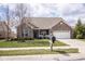 Inviting single-Gathering home with a well-manicured lawn and an attached two-car garage at 9752 Brook Wood Dr, McCordsville, IN 46055