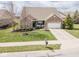Inviting single-Gathering home with a well-manicured lawn and an attached two-car garage at 9752 Brook Wood Dr, McCordsville, IN 46055