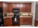 Charming kitchen with stainless steel appliances, granite countertops, and dark wood cabinets for a stylish look at 9752 Brook Wood Dr, McCordsville, IN 46055