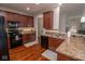 Well-equipped kitchen with updated appliances, ample counter space, and warm wood cabinetry and flooring at 9752 Brook Wood Dr, McCordsville, IN 46055