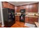 Stylish kitchen features black appliances, ample storage space, and a functional layout for easy meal preparation at 9752 Brook Wood Dr, McCordsville, IN 46055