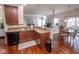 Well-designed kitchen connects to a cozy living space with comfortable seating and hardwood floors at 9752 Brook Wood Dr, McCordsville, IN 46055