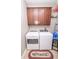 Convenient laundry area with modern washer and dryer and overhead cabinets at 9752 Brook Wood Dr, McCordsville, IN 46055