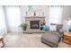 Cozy living room featuring a stone fireplace, plush carpeting, and ample natural light at 9752 Brook Wood Dr, McCordsville, IN 46055