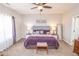 Comfortable main bedroom showcasing a plush king bed, soft carpet, and a ceiling fan at 9752 Brook Wood Dr, McCordsville, IN 46055