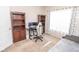 Comfortable home office space complete with a desk, monitor and chair. Includes a bookshelf at 9752 Brook Wood Dr, McCordsville, IN 46055