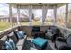 Cozy screened-in porch with comfortable seating and view of the outdoors at 9752 Brook Wood Dr, McCordsville, IN 46055