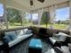 Cozy screened-in porch with cushioned seating, decorative pillows, and neighborhood view at 9752 Brook Wood Dr, McCordsville, IN 46055