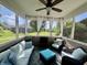 Relaxing screened-in porch with comfortable seating, ceiling fan, and backyard views at 9752 Brook Wood Dr, McCordsville, IN 46055