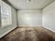 This interior shot reveals an empty bedroom with a window, awaiting new life and design at 980 Edgemont Ave, Indianapolis, IN 46208
