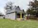 Exterior view showcasing the house's facade, colorful porch and well-maintained lawn at 980 Edgemont Ave, Indianapolis, IN 46208