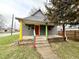 Exterior view of a gray house with a colorful front porch in a residential area at 980 Edgemont Ave, Indianapolis, IN 46208