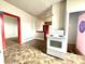 Open concept kitchen featuring white appliances, colorful trim, and unique flooring at 980 Edgemont Ave, Indianapolis, IN 46208