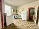Eclectic kitchen with colorful cabinets, white appliances, and unique flooring at 980 Edgemont Ave, Indianapolis, IN 46208
