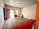 Bright living room featuring carpet, colorful door frames, and a view of the outside at 980 Edgemont Ave, Indianapolis, IN 46208