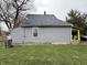 A side view of a single-Gathering home with a gray roof and a green yard at 980 Edgemont Ave, Indianapolis, IN 46208